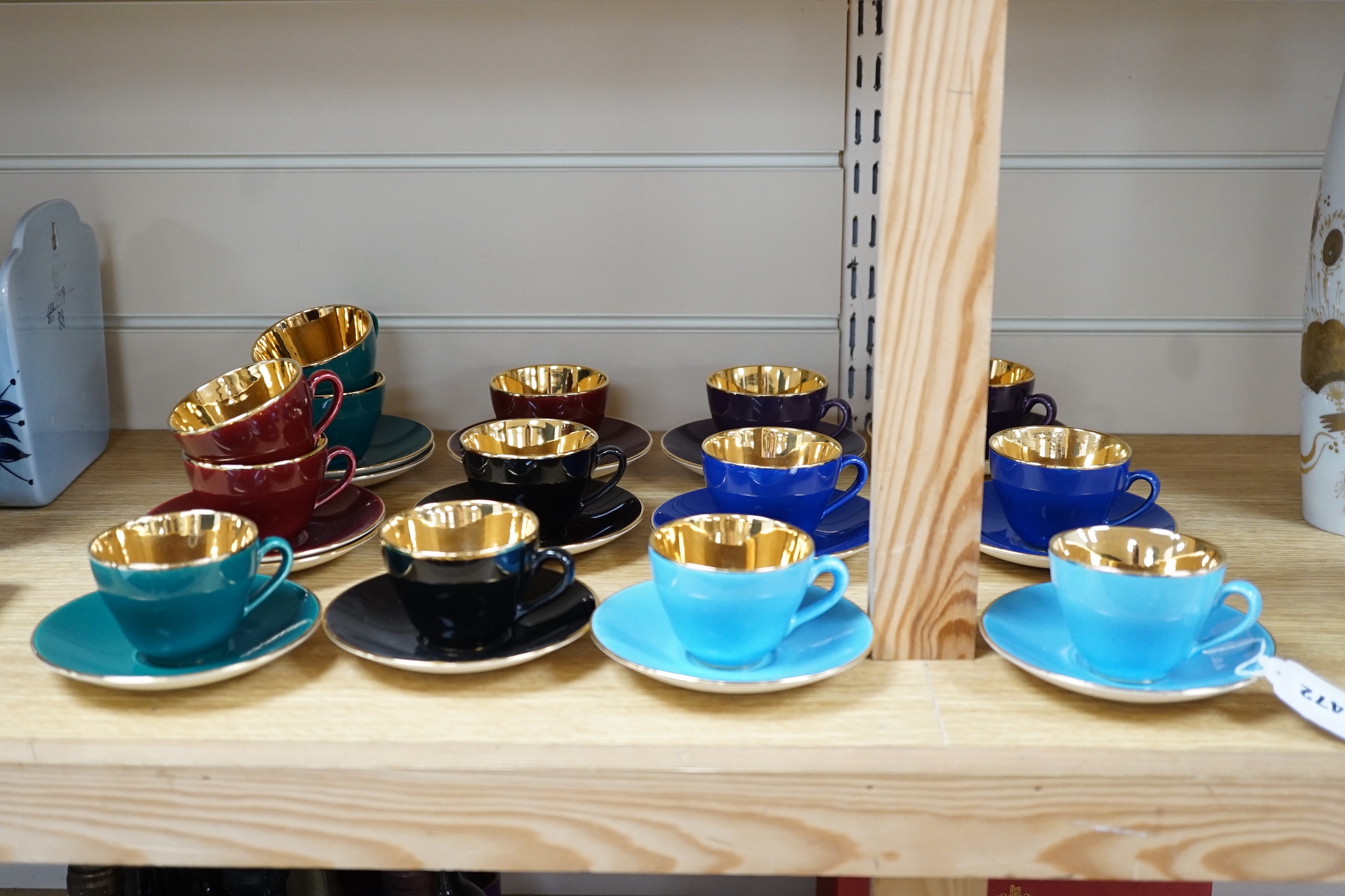 Fourteen Copenhagen Alumina, ‘Confetti’ patterned coffee cups and saucers in varying colours with gilt interiors